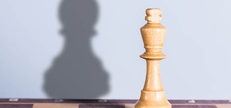 White chess king with pawn shadow
